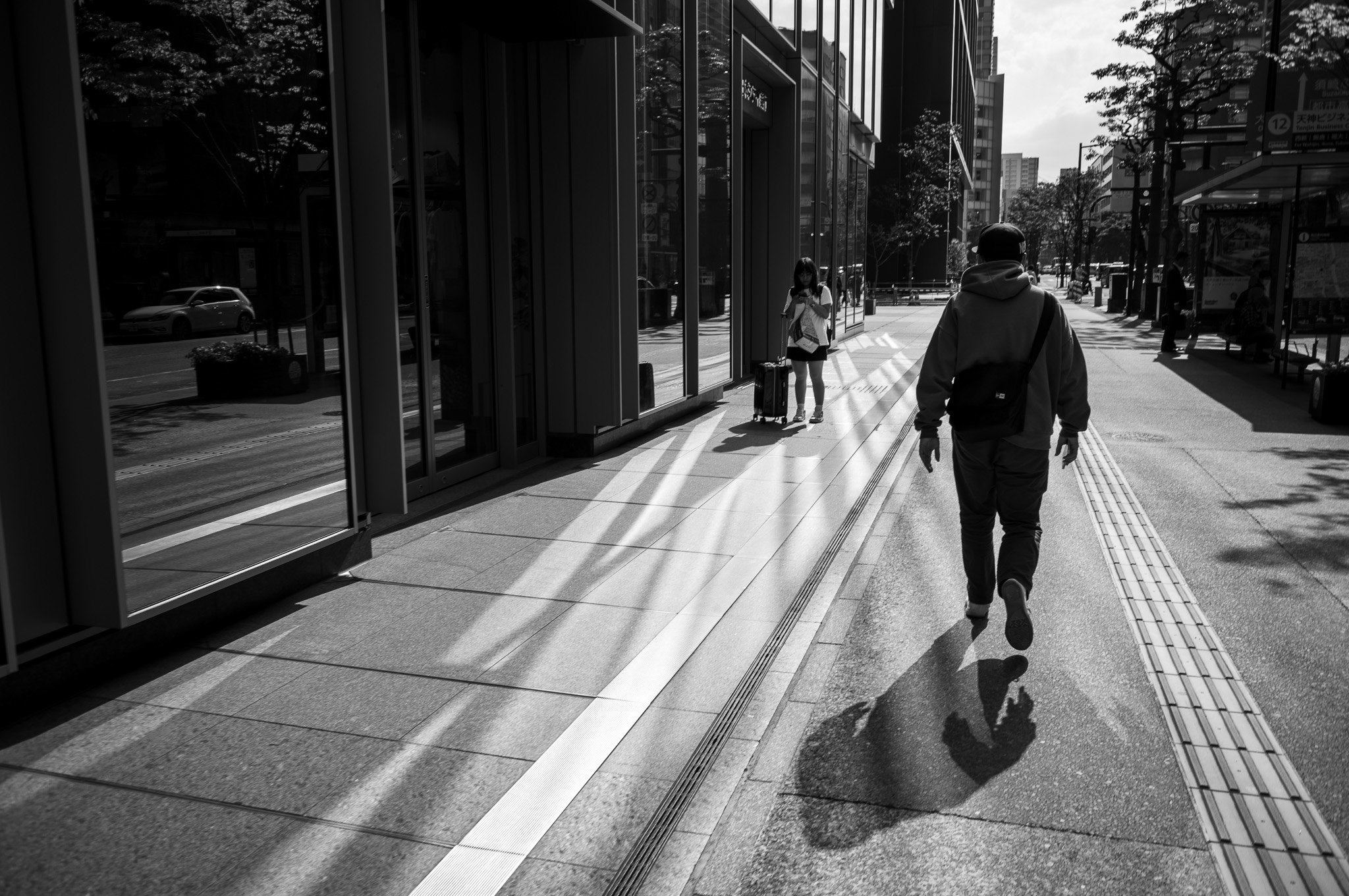 A man walks into the shadow he is already casting.