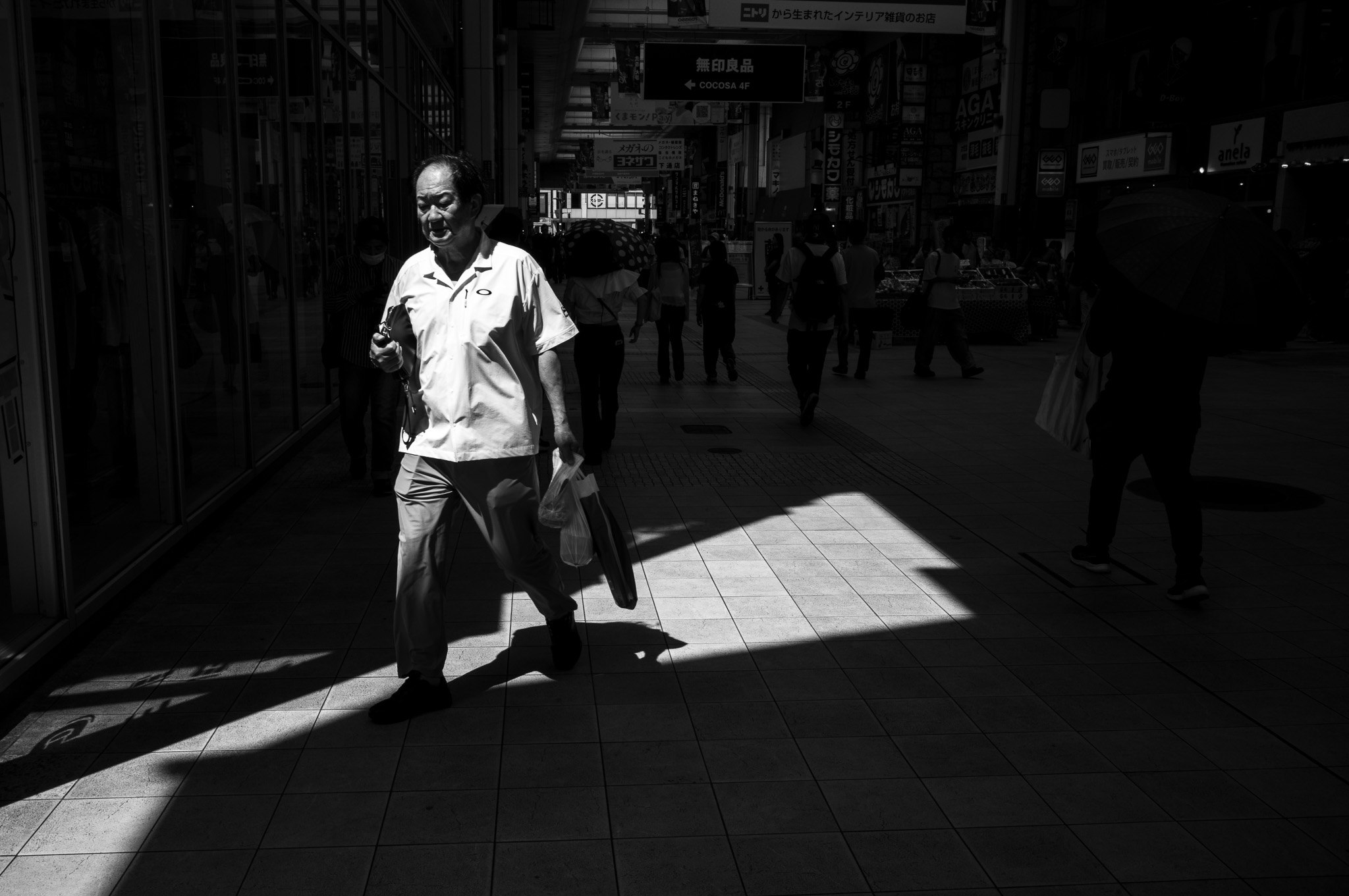 Of all this shade, the light chose exactly one man to stand in.
