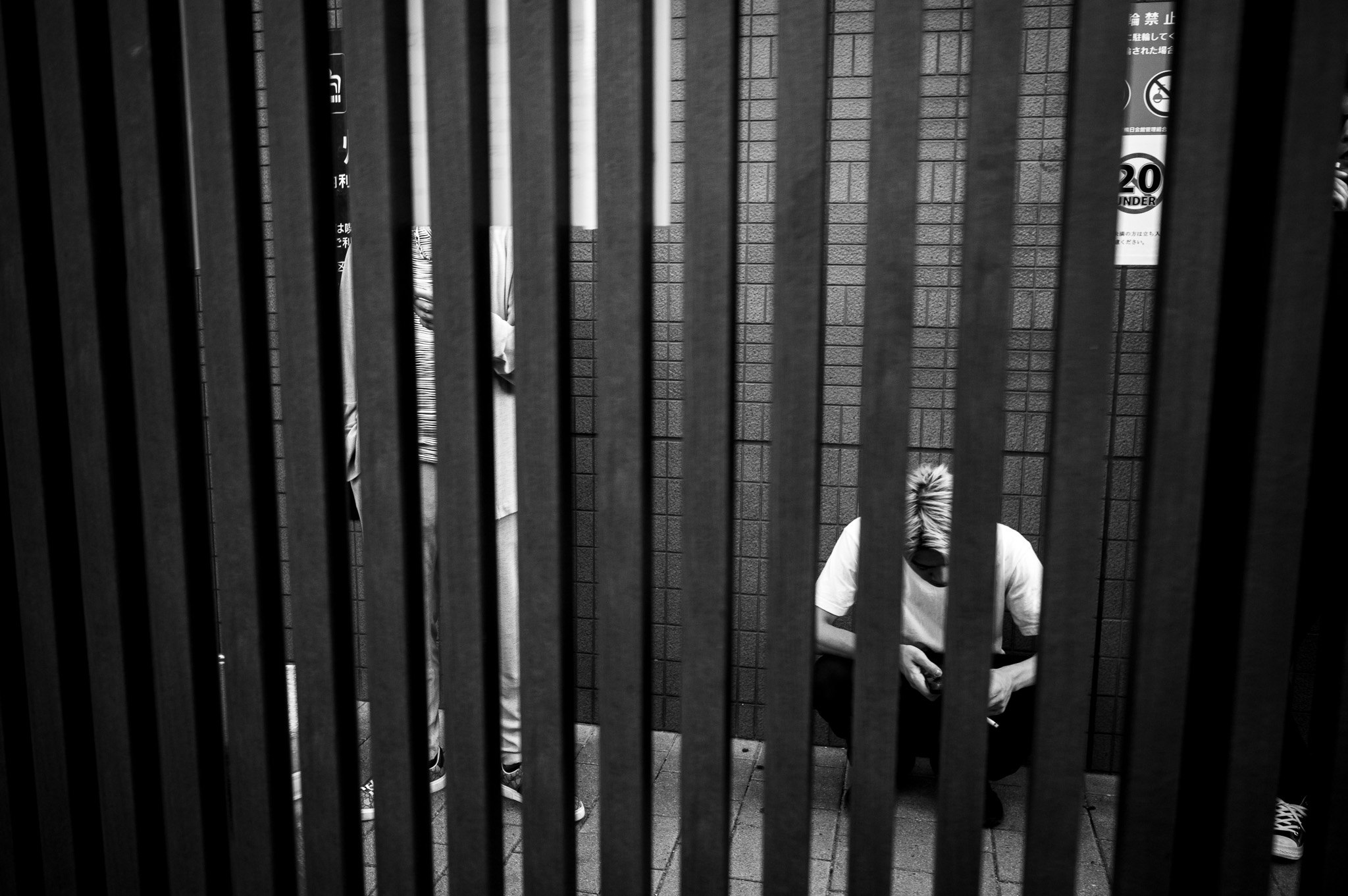 The slats count him out, one bar at a time.