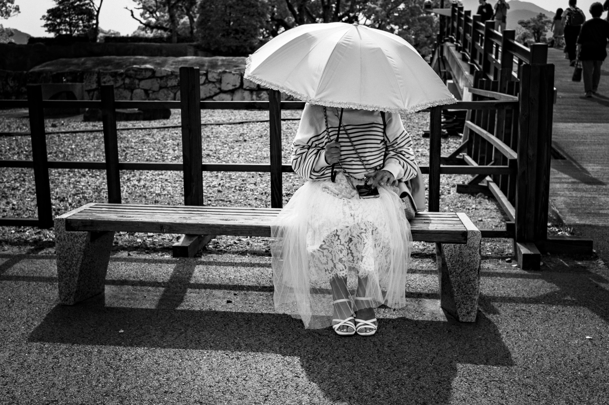 The umbrella keeps her face for itself, and the lace decides to be seen instead.